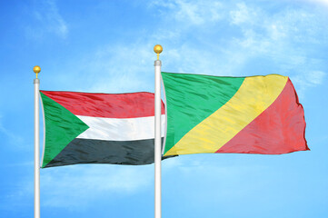 Sudan and Congo two flags on flagpoles and blue sky