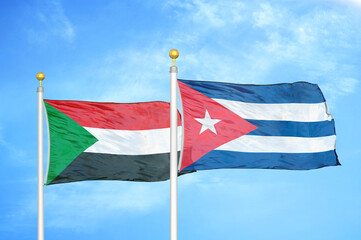 Sudan and Cuba two flags on flagpoles and blue sky
