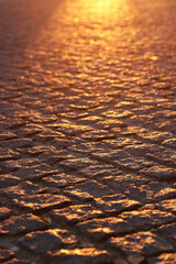 an old road made of stone in the sunset sunlight