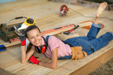 Carpenter woman is at work. Building as a hobby. Beautiful woman with construction tools