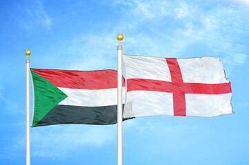 Sudan and England two flags on flagpoles and blue sky