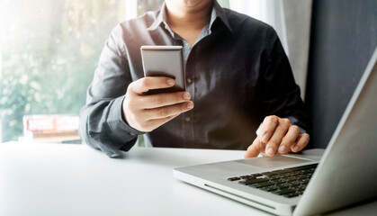 businesswoman hand using smart phone,mobile p payments online shopping,omni channel,digital tablet docking keyboard computer at office in sun light