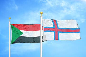 Sudan and Faroe Islands two flags on flagpoles and blue sky