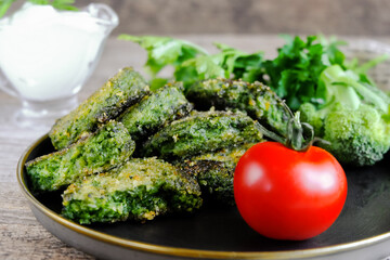  Fried vegetarian patties on a plate with the tomatoes. Healthy vegetarian or vegan food. On a wooden table.