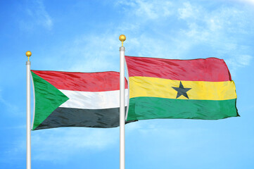 Sudan and Ghana two flags on flagpoles and blue sky