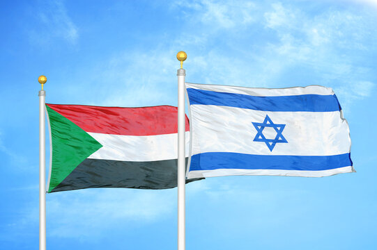 Sudan And Israel Two Flags On Flagpoles And Blue Sky