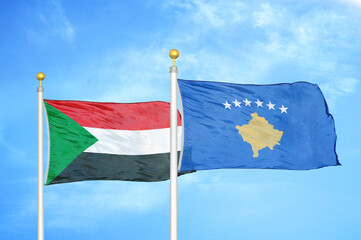 Sudan and Kosovo two flags on flagpoles and blue sky