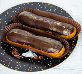 Gorgeous extra chocolate eclairs with gilded glaze