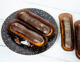 Gorgeous extra chocolate eclairs with gilded glaze