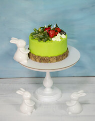 A green creamchease cake with berries and marmalade