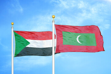 Sudan and Maldives two flags on flagpoles and blue sky