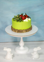 A green creamchease cake with berries and marmalade