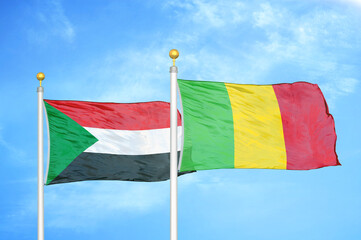 Sudan and Mali two flags on flagpoles and blue sky