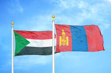Sudan and Mongolia two flags on flagpoles and blue sky