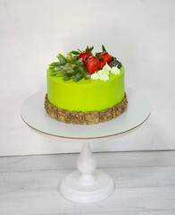 A green creamchease cake with berries and marmalade