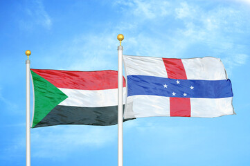 Sudan and Netherlands Antilles two flags on flagpoles and blue sky