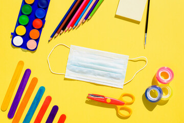 Creativity at school is developed with colorful materials and with the protection of a mask to...