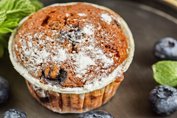 Freshly baked blueberry muffins. Cupcakes sprinkled with powdered Sugar.