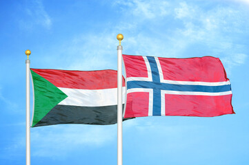 Sudan and Norway two flags on flagpoles and blue sky