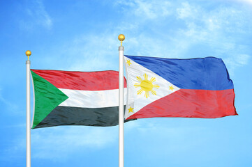 Sudan and Philippines two flags on flagpoles and blue sky