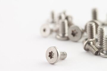 Bunch metal industry grey chrome new bolts isolated white background macro