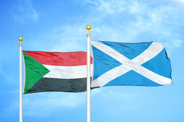 Sudan and Scotland two flags on flagpoles and blue sky