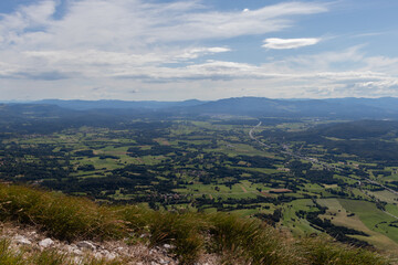 Obraz premium Highway passing through valley with small forests and fields in Europe. 