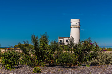 A view past the gardens in the ruins of Edmunds priory toward the old lighthouse at Hunstanton, Norfolk, UK