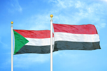 Sudan and Yemen two flags on flagpoles and blue sky