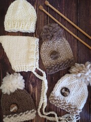 wooden knitting needles and hand made wooly hats 