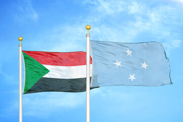Sudan and Micronesia two flags on flagpoles and blue sky