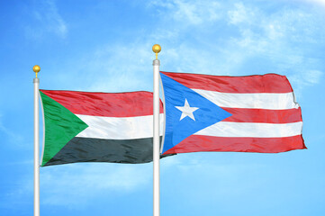 Sudan and Puerto Rico two flags on flagpoles and blue sky