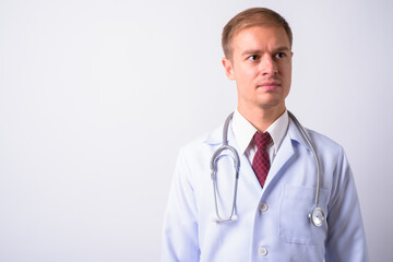 Fototapeta premium Portrait of handsome man doctor against white background