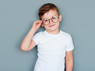 Portrait of young boy wearing glasses, studio