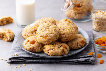 Healthy vegan oat cookies with glass of milk. Grey background. Close up.