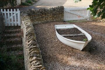 white boat near cobble stone path with stairs and stone wall