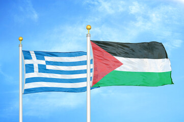 Greece and Palestine two flags on flagpoles and blue sky