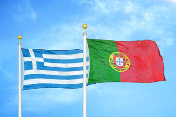 Greece and Portugal two flags on flagpoles and blue sky