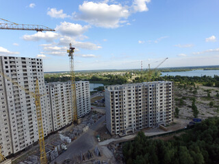 Aerial view of construction site of residential area buildings with cranes. Kiev, Ukraine