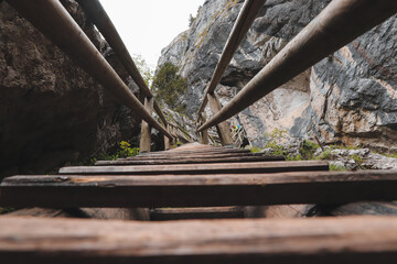 Old but solid wooden ladder in a beautiful gorge in the southeast of Austria in Styria. Bear gorge. Barenschutzklamm. Route to the treasure. Trail along beautiful waterfalls in the Fischbach Alps.