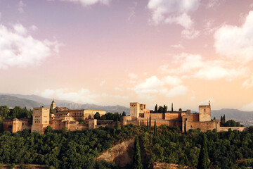 Granada landscape at sunset, with the Alhambra, the mountains in the background, trees and the sky with clouds for a nice postcard or wallpaper