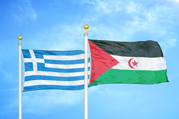 Greece and Western Sahara two flags on flagpoles and blue sky