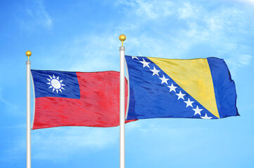 Taiwan and Bosnia and Herzegovina two flags on flagpoles and blue sky