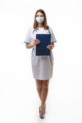 girl doctor in medical clothes and mask with tablet in hand on white background - obrazy, fototapety, plakaty