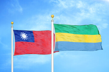 Taiwan and Gabon two flags on flagpoles and blue sky