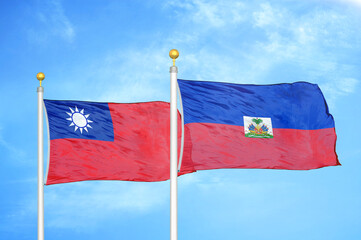 Taiwan and Haiti two flags on flagpoles and blue sky