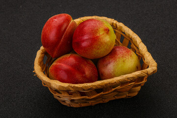 Sweet small nectarines in the basket