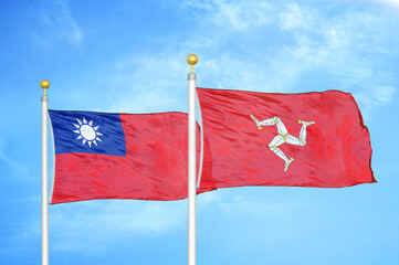 Taiwan and Isle of Mann two flags on flagpoles and blue sky