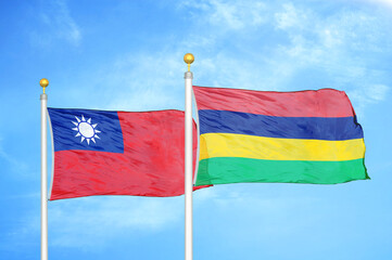Taiwan and Mauritius two flags on flagpoles and blue sky