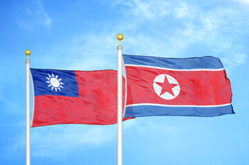 Taiwan and North Korea two flags on flagpoles and blue sky